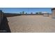 Gravel-covered backyard with a gazebo and mature landscaping in the distance at 4088 N 309Th Cir, Buckeye, AZ 85396