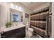 Clean bathroom with modern vanity, updated mirror, and shower at 4088 N 309Th Cir, Buckeye, AZ 85396
