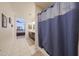 Tiled bathroom shower with blue shower curtain and decor, showcasing a clean and stylish design at 4088 N 309Th Cir, Buckeye, AZ 85396