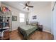 Cozy bedroom with wood-look flooring, ceiling fan, and natural light at 4088 N 309Th Cir, Buckeye, AZ 85396