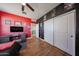 Large bedroom with red accent wall, modern desk, and closet at 4088 N 309Th Cir, Buckeye, AZ 85396