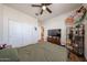 Bedroom featuring wood-look floors, a ceiling fan, and closet with sliding doors at 4088 N 309Th Cir, Buckeye, AZ 85396