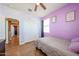 Bright bedroom featuring wood-look floors, and closet with sliding doors at 4088 N 309Th Cir, Buckeye, AZ 85396