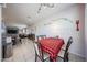 Spacious dining room with decorative wall art, a red and black checkered tablecloth, and open access to living areas at 4088 N 309Th Cir, Buckeye, AZ 85396