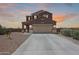 Charming two-story home with a spacious driveway and a welcoming facade, perfect for Gathering living at 4088 N 309Th Cir, Buckeye, AZ 85396