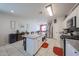 Modern kitchen with a central island, white cabinetry, and stainless steel appliances at 4088 N 309Th Cir, Buckeye, AZ 85396