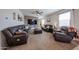 Comfortable living room features plush seating, a ceiling fan, and a unique accent wall at 4088 N 309Th Cir, Buckeye, AZ 85396