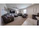 Stylish living room featuring modern decor, a ceiling fan, and comfortable leather furniture at 4088 N 309Th Cir, Buckeye, AZ 85396