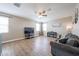 Open-concept living room features wood flooring, ceiling fan and natural light at 4088 N 309Th Cir, Buckeye, AZ 85396