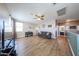 Spacious living room with hardwood floors, ceiling fan, piano, and sofa at 4088 N 309Th Cir, Buckeye, AZ 85396