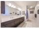 Bright main bathroom with double sinks, a large mirror, and ample counter space for a functional design at 4088 N 309Th Cir, Buckeye, AZ 85396