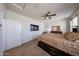 Serene main bedroom with a mounted TV, ceiling fan, and neutral tones, creating a relaxing and private retreat at 4088 N 309Th Cir, Buckeye, AZ 85396