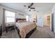 Inviting main bedroom with a cozy bed, ceiling fan, and adjacent bathroom entry, offering comfort and convenience at 4088 N 309Th Cir, Buckeye, AZ 85396