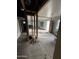 Open floor plan during renovation with exposed framing, natural light, and an adjacent room, showing potential for customization at 4418 N 19Th Pl, Phoenix, AZ 85016