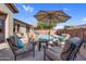 Backyard with a pool, lounge chairs, and an umbrella surrounded by lush greenery at 4821 E Kirkland Rd, Phoenix, AZ 85054