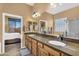 Bathroom with dual sinks, granite countertops, and a separate door to the bedroom at 4821 E Kirkland Rd, Phoenix, AZ 85054