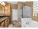 Bathroom featuring a soaking tub, step-in shower, and a spacious vanity with dark wood cabinets at 4821 E Kirkland Rd, Phoenix, AZ 85054