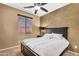 Bedroom with a ceiling fan, bedside table, and natural light coming through the window at 4821 E Kirkland Rd, Phoenix, AZ 85054