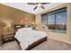 Cozy bedroom with a ceiling fan and a view of the pool through the window at 4821 E Kirkland Rd, Phoenix, AZ 85054