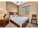 Bedroom with a wooden bedframe and textured walls with plenty of natural light coming in at 4821 E Kirkland Rd, Phoenix, AZ 85054