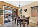 Inviting dining area with stone floors and sliding glass doors to a cozy patio fireplace at 4821 E Kirkland Rd, Phoenix, AZ 85054