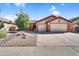 Beautiful home exterior with a three-car garage, desert landscaping, and mature trees, offering curb appeal at 4821 E Kirkland Rd, Phoenix, AZ 85054