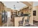Kitchen featuring a breakfast bar, stainless steel appliances, and dark wood cabinetry at 4821 E Kirkland Rd, Phoenix, AZ 85054