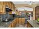 Gourmet kitchen featuring granite counters, stainless steel appliances, custom wood cabinets, and a gas range cooktop at 4821 E Kirkland Rd, Phoenix, AZ 85054