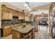 Well-equipped kitchen with custom wood cabinets, granite countertops, and an island with a view to the living space at 4821 E Kirkland Rd, Phoenix, AZ 85054