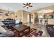 Spacious living room with a tile floor, leather sectional, and open layout connecting to the kitchen and dining area at 4821 E Kirkland Rd, Phoenix, AZ 85054