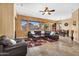 Bright and airy living room with tile flooring, a large leather sectional, and views of the outdoor patio and backyard at 4821 E Kirkland Rd, Phoenix, AZ 85054