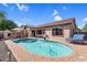 An inviting backyard pool is surrounded by brick patio and lounge furniture under a bright blue, partly cloudy sky at 4821 E Kirkland Rd, Phoenix, AZ 85054