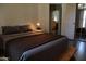 A cozy bedroom featuring a comfortable bed and an ensuite bathroom entrance at 5720 S 21St Ter, Phoenix, AZ 85040