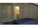 Bedroom with ensuite bathroom access and unique glass block partition feature at 5720 S 21St Ter, Phoenix, AZ 85040