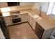Bright kitchen with granite countertops, stainless steel appliances, white cabinetry, and hardwood floors at 5720 S 21St Ter, Phoenix, AZ 85040
