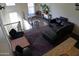 Cozy living room with hardwood floors, a dark sofa, and a staircase with wrought iron railings at 5720 S 21St Ter, Phoenix, AZ 85040