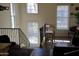 Bright living room with hardwood floors, a staircase with wrought iron railings, and large windows at 5720 S 21St Ter, Phoenix, AZ 85040