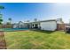 Spacious backyard with pool, basketball hoop, and grass at 591 N Cheri Lynn Dr, Chandler, AZ 85225