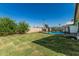 Backyard features a fenced pool area, fruit tree and grassy lawn at 591 N Cheri Lynn Dr, Chandler, AZ 85225