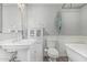 Classic bathroom with a pedestal sink, a freestanding tub, and white wainscoting at 591 N Cheri Lynn Dr, Chandler, AZ 85225