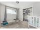 Neutral toned bedroom with a window, walk-in closet, daybed and crib at 591 N Cheri Lynn Dr, Chandler, AZ 85225