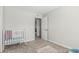 Sunlit bedroom with plush carpet, neutral toned walls and a white crib at 591 N Cheri Lynn Dr, Chandler, AZ 85225