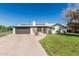 Charming single-story home with a brick facade, well-manicured lawn, and a two-car garage at 591 N Cheri Lynn Dr, Chandler, AZ 85225