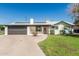 Inviting single-story home featuring a well-kept lawn, a two-car garage, and lovely stone accents at 591 N Cheri Lynn Dr, Chandler, AZ 85225