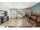 Inviting living room with stone fireplace and desert mural, complete with tile flooring and ample natural light at 591 N Cheri Lynn Dr, Chandler, AZ 85225