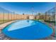 Private backyard pool enclosed with secure fencing and a basketball hoop at 591 N Cheri Lynn Dr, Chandler, AZ 85225