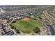 Wide aerial shot of a Gathering-friendly neighborhood with a baseball field and many green spaces at 6948 E Quill St, Mesa, AZ 85207