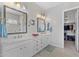 Bathroom with double sinks, framed mirrors, marble countertops and closet entrance at 6948 E Quill St, Mesa, AZ 85207