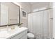 White bathroom featuring a vanity with a sink and a shower with a white patterned curtain at 6948 E Quill St, Mesa, AZ 85207