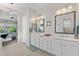 Spacious bathroom with double sinks, marble countertops, and doorway leading to a bedroom at 6948 E Quill St, Mesa, AZ 85207